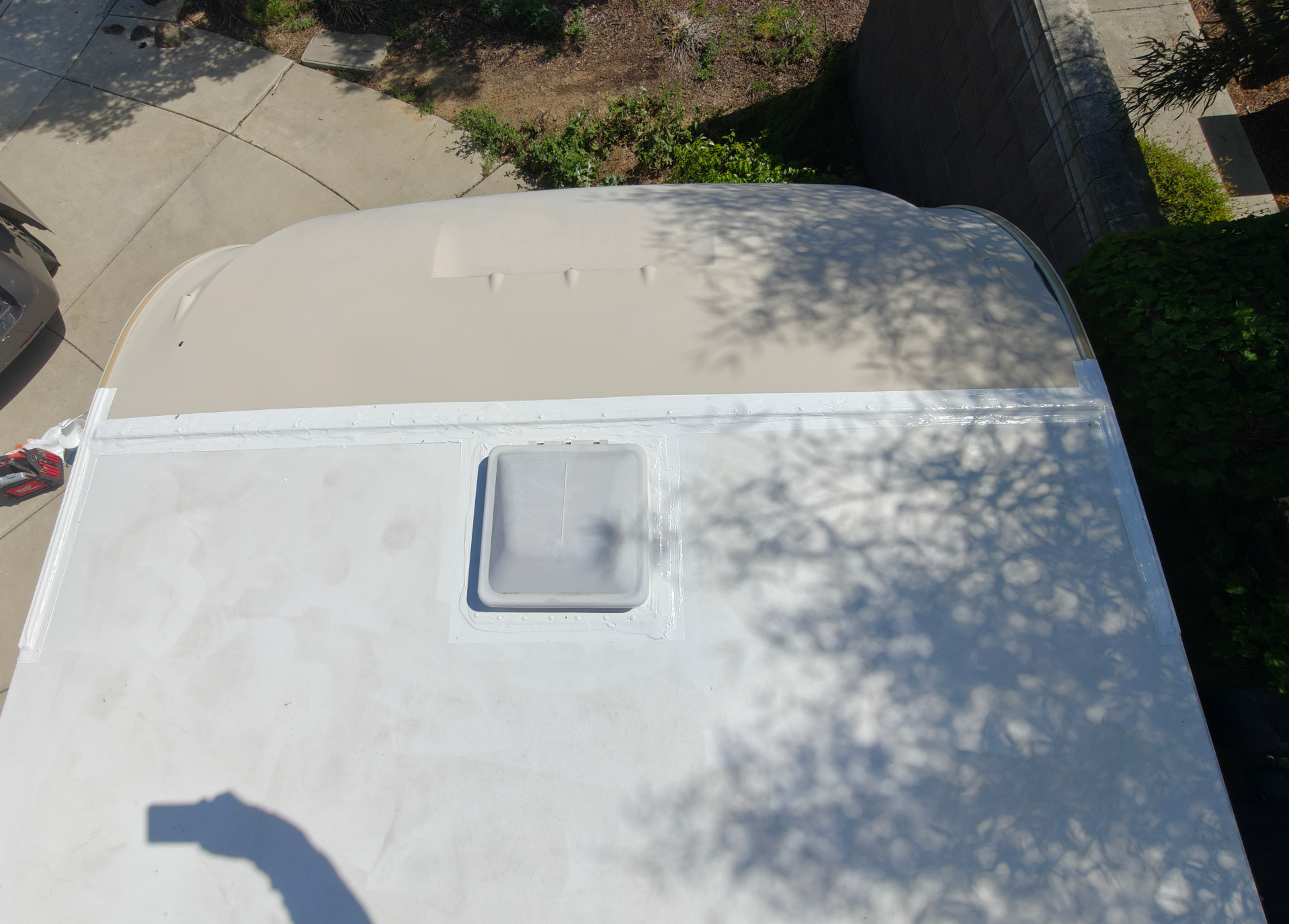 Secured termination bar and sealed vent on RV roof after maintenance