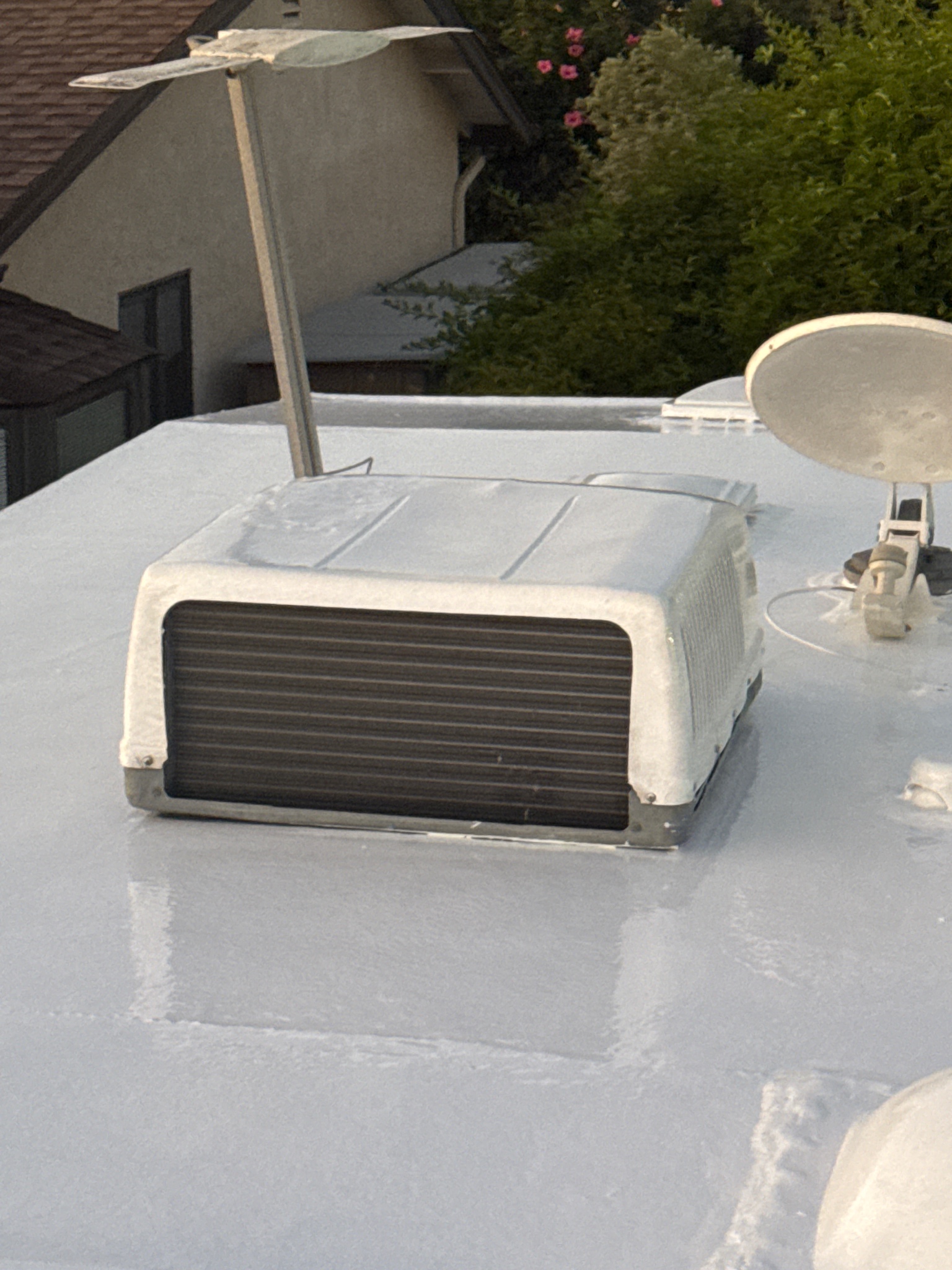 Silicone applied around AC unit on RV roof after repair