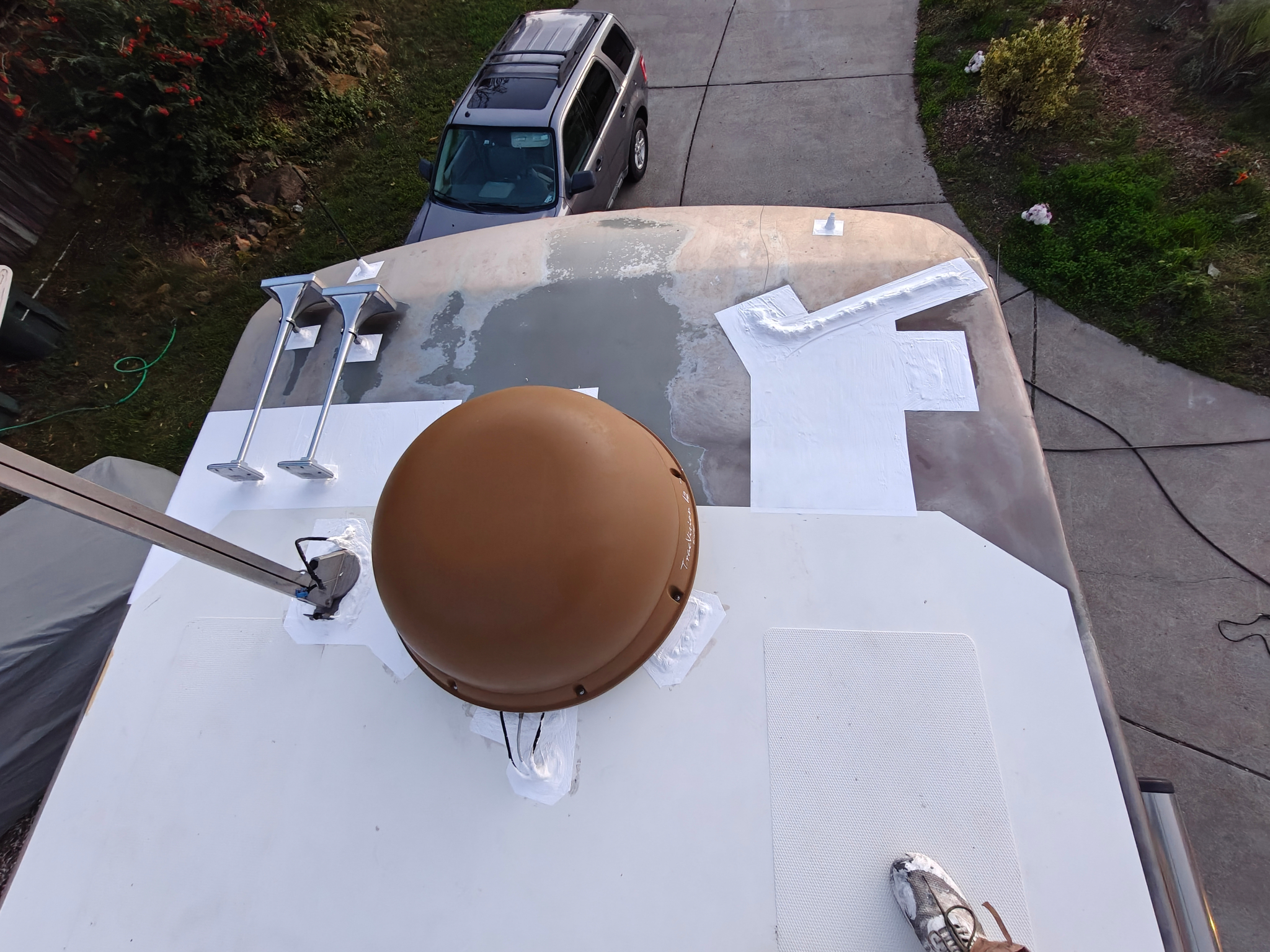 Sealed front section of RV roof near antenna after maintenance with clean finish
