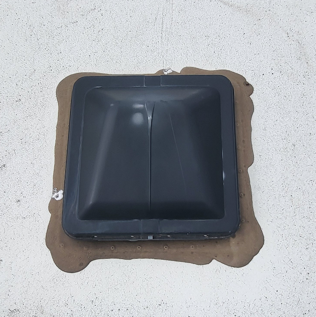 Old RV roof vent with worn and deteriorated sealant before repair
