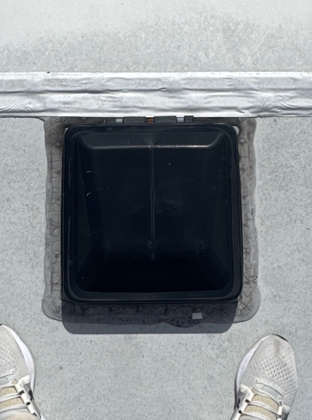 Old RV roof vent with worn sealant before replacement