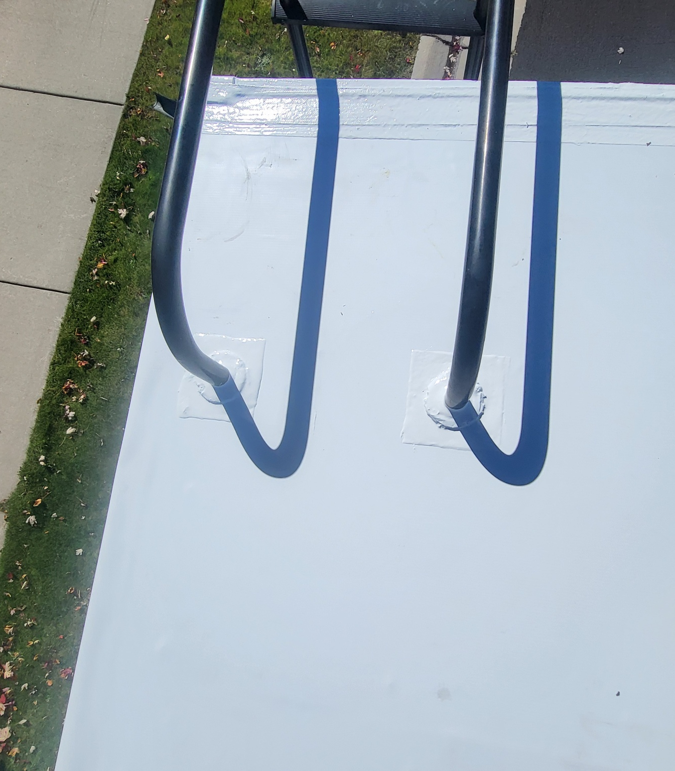 Sealed ladder mounts on RV roof after replacement with clean finish