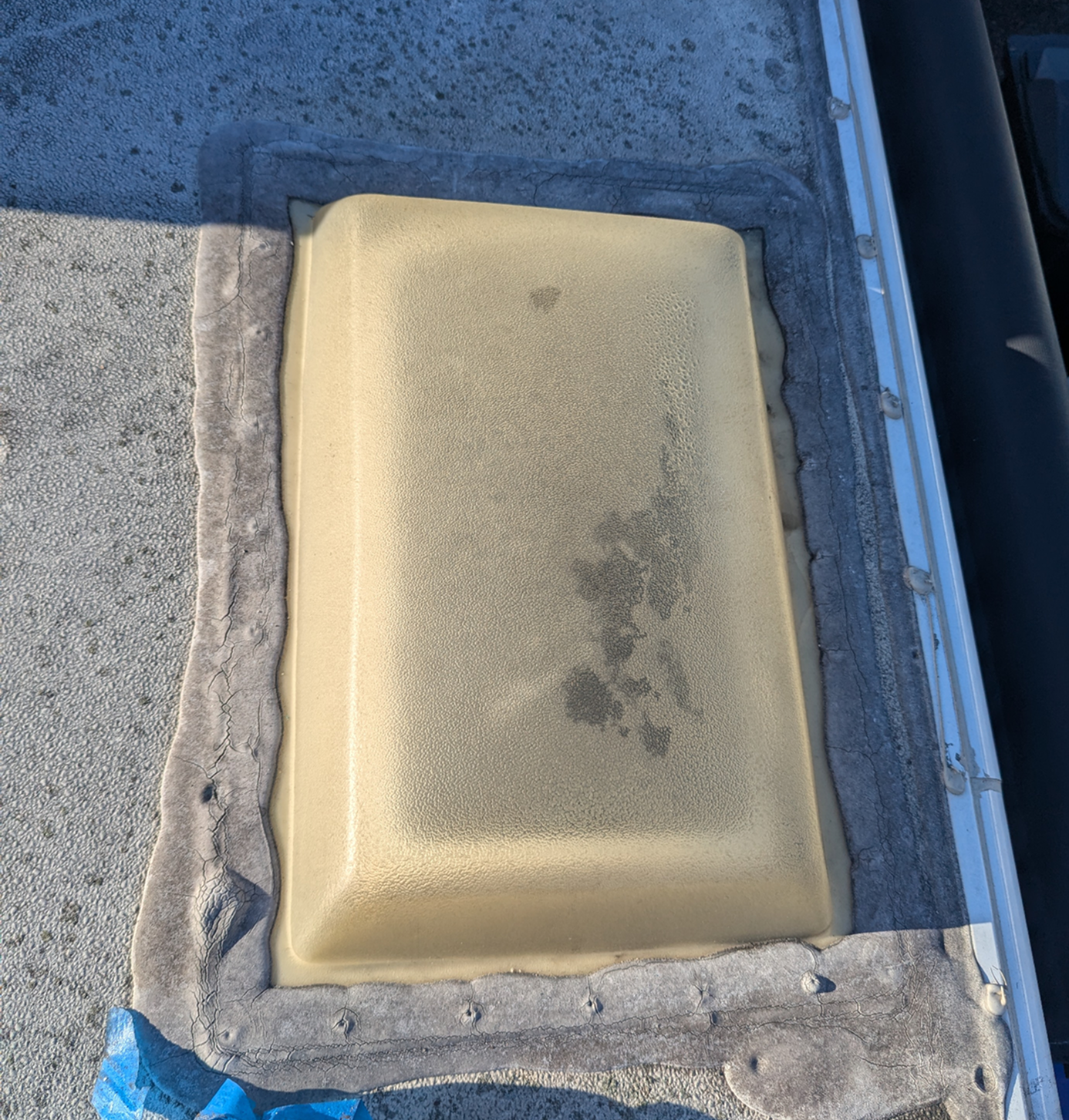 Old RV skylight with dirty and deteriorated sealant before repair