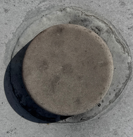 Old plumbing vent with dirty and deteriorated sealant on RV roof before repair