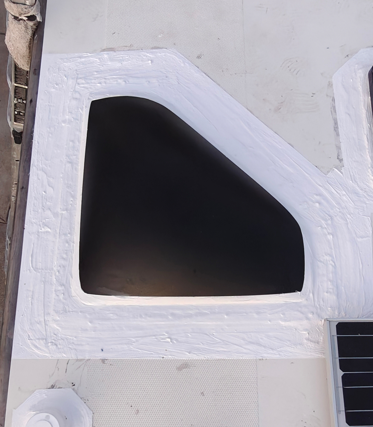 Sealed skylight on RV roof after maintenance with reinforced silicone