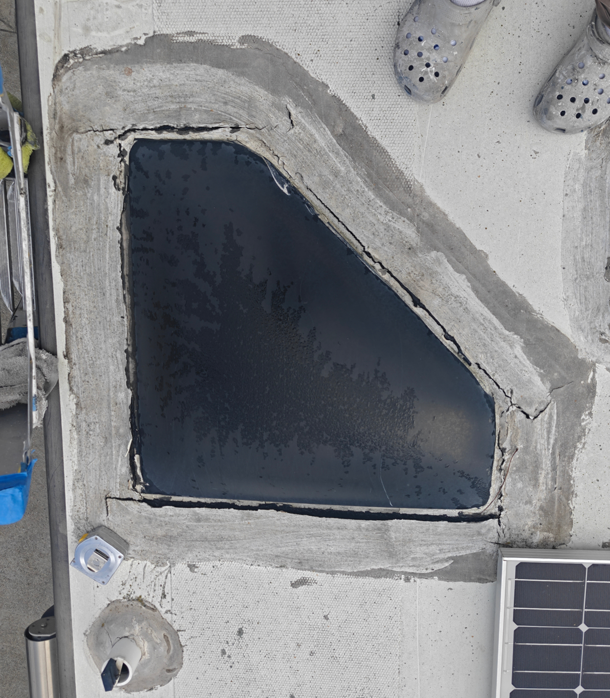 Cracked sealant around skylight on RV roof before maintenance